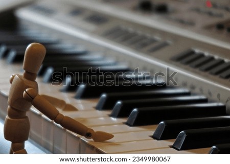 Matrix and wooden human playing piano