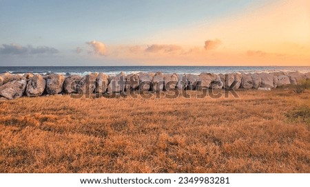 Large boulders on Palisadoes a thin strip of sand that serves as a natural protection for Kingston Harbour, Jamaica