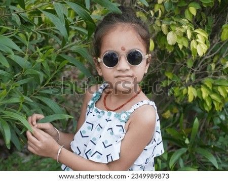 Awesome photo present filter effect on portrait sunset cute little girl image. Natural blur background and clear focus. Dark mode of adventure scenery. Different close up hand style wearing black.