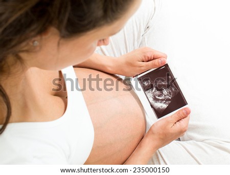 young pregnant woman looking at baby scan
