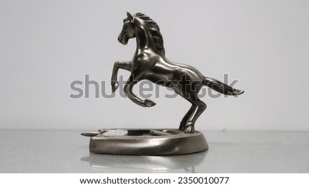 miniature silver horse statue made of metal. Royalty-Free Stock Photo #2350010077