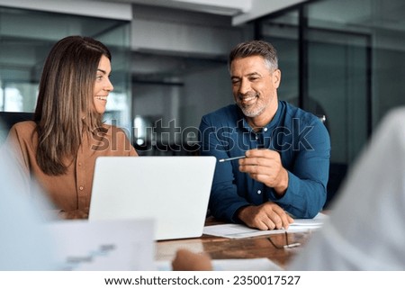 Professional executive team working at meeting in office. Older business man manager leader talking to board people consulting partners investors discussing digital project management in teamwork. Royalty-Free Stock Photo #2350017527