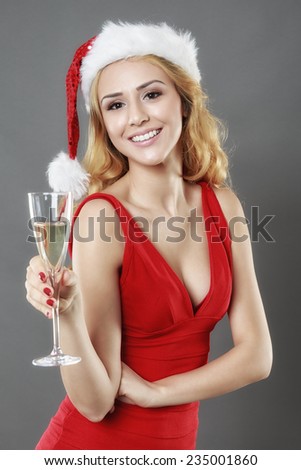 party, drinks, christmas, x-mas concept - smiling woman in red dress with a glass of champagne
