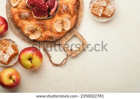 Jewish Holidays - Rosh Hashanah or Rosh Hashana. Pomegranate, apples, honey and round challah on rustic grey table background. Jewish Autumn celebration. Shana Tova. Yom kippur concept. Top view.