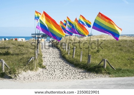 pride flags on the beach of baltic sea