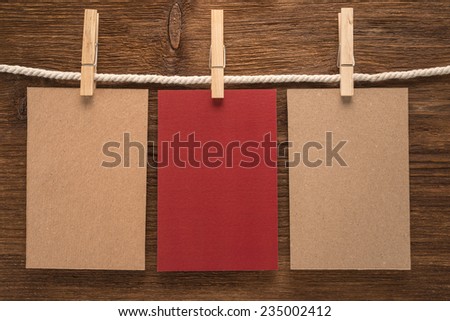 Notes and a clothes pegs on wooden background  