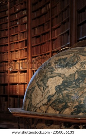 antique astronomical globe in front of an old library 