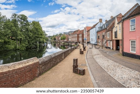 Pretty multi coloured houses pictured along the side of the River Wensum in Norwich in August 2023.