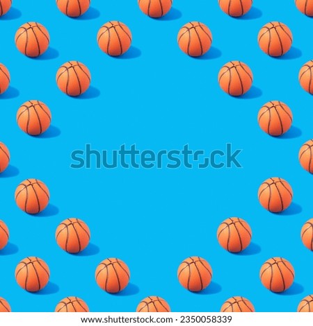 Pattern made of orange basketball on blue background with copy space. Creative sport concept.