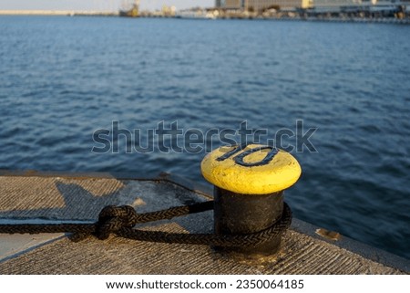 Rope hooked to a peg in the bay of Gdynia, Poland Royalty-Free Stock Photo #2350064185