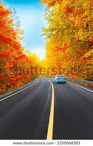 car driving on asphalt road in autumn season. highway landscape in autumn. Road scenery in beautiful forest with colorful trees in fall landscape. Nature landscape on beautiful road in colorful fall. Royalty-Free Stock Photo #2350068583