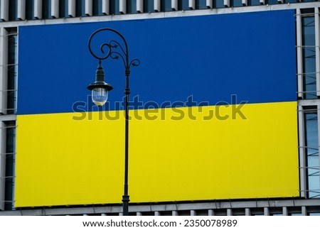 Lantern on the background of a large flag of Ukraine 