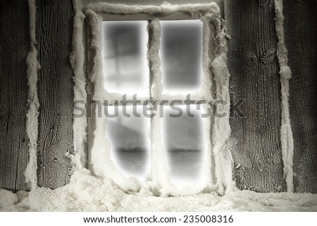 holiday photo of window of snow and wooden old wall of home 