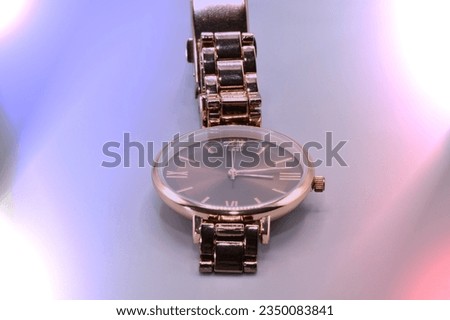 A dark copper toned watch.