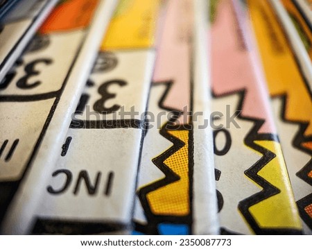 Closeup view of an old comic book collection stacked in a pile creates a colorful background paper texture with abstract shapes Royalty-Free Stock Photo #2350087773