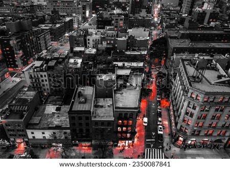 Red lights shining in a black and white cityscape overlooking the buildings of Manhattan in New York City at night