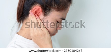Woman holding her painful Ear. Ear disease, Atresia, Otitis Media, Inflation, Pertorated Eardrum, Meniere syndrome, otolaryngologist, Ageing Hearing Loss and Health concept Royalty-Free Stock Photo #2350104263