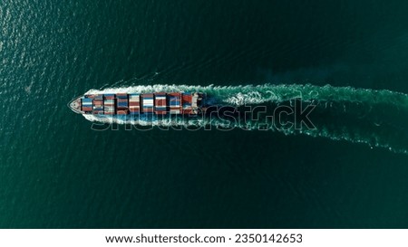 cargo container ship sailing full speed in sea to import export goods and distributing products to dealer and consumers worldwide, by container ship Transport business delivery service, aerial view Royalty-Free Stock Photo #2350142653