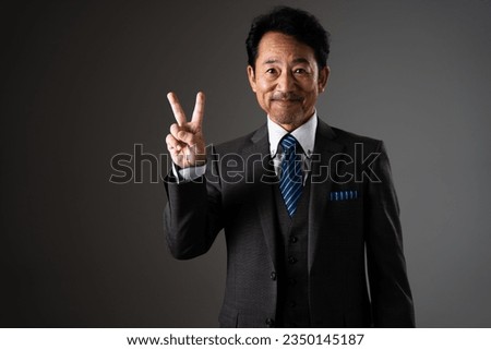 Business image of a middle man who makes a peace sign