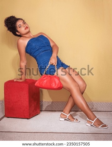 Afro hair girl in photo poses in clothing store clothes apparel.
