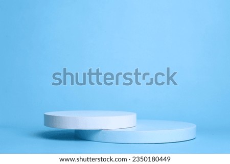 Empty stacks of cylinder podium for product presentation, display or cosmetics showcase on blue background