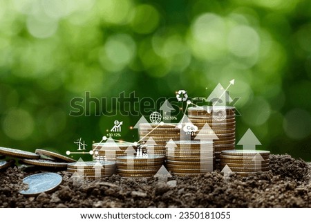 Investment Ideas and Business Growth. Coins stacked on the ground with a digital graph. Green business growth. Finance sustainable development. Investing in renewable energy is crucial for the future. Royalty-Free Stock Photo #2350181055