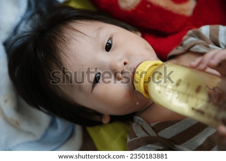 Cute baby feed on milk.