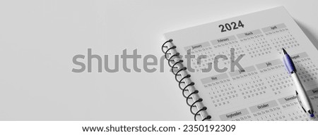Calendar Year 2024 schedule with note for to do list on white background. Flat lay with calendar, pencil on calander 2024. Close up of pencil on page of calendar 2023