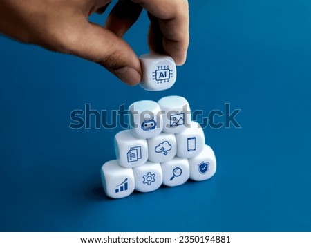 AI technology concepts. Artificial intelligence support work, reduce workloads and increase efficiency. AI chip icon in hand on top of blocks stack with online digital IOT symbols on blue background.