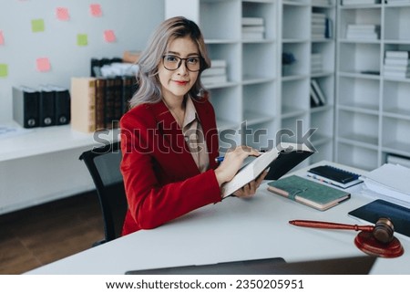 Portrait of a Asian woman lawyer studying a lawsuit for a client before going to court.