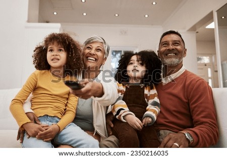 Home, kids and grandparents watch television series, subscription movie or streaming video, media or entertainment. Lounge sofa, family or relax grandmother, grandfather and children watching tv show Royalty-Free Stock Photo #2350216035