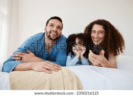 Bedroom, happy family child and parents watching tv series, movie or streaming online video, cinema or theatre together. Bed, home and relax mom, dad and kid watch cartoon show, television or film