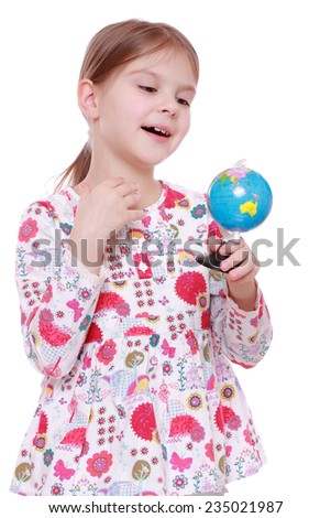 Cheerful and smiling little girl holding and offering globe
