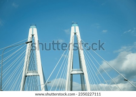 Cable-stayed bridge pylons against the blue sky Royalty-Free Stock Photo #2350227111