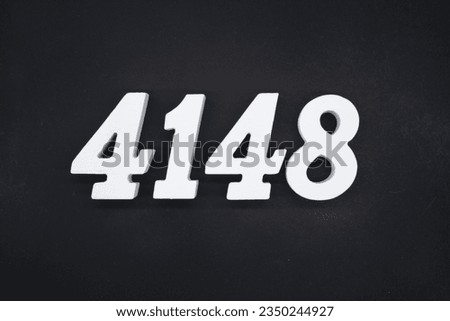 Black for the background. The number 4148 is made of white painted wood.