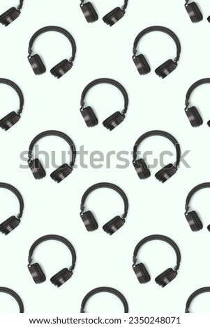 Pattern made of wireless headphones on a blue background. Creative layout.