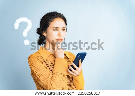 Worried young woman with a smart phone. Royalty-Free Stock Photo #2350258017