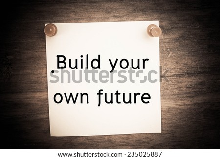 Text build your own future on note paper 