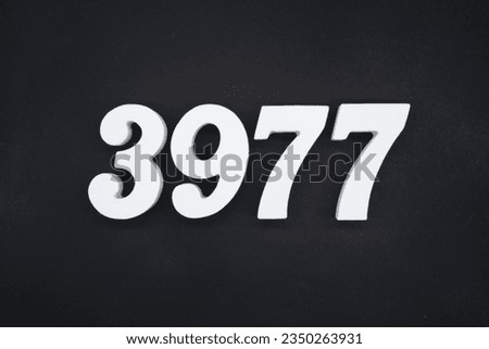 Black for the background. The number 3977 is made of white painted wood.