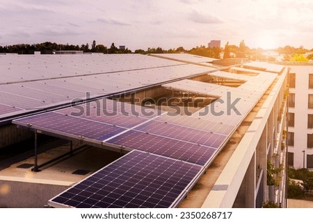 Solar Panel Roof Multifamily Apartment Building on Cityscape Backgroung. Modern High rise House with Solar Battery on Rooftop in Green City. Solar Energy Efficiency. Royalty-Free Stock Photo #2350268717