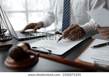 Businessmen or lawyers working together at a meeting, teamwork and partnership. Signing documents, contracts, checking details business agreement