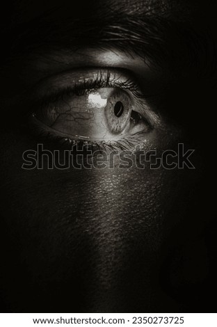 mystery man hidden eye  spying  in the shadows Royalty-Free Stock Photo #2350273725