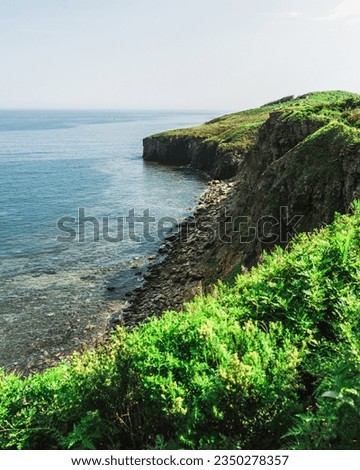 Sea and mountain range. large rocks on the beach and in the ocean. Cliff by the sea. Selective focus.