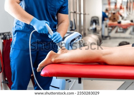 Physical therapy of foot with acoustic shock waves, close up. Royalty-Free Stock Photo #2350283029