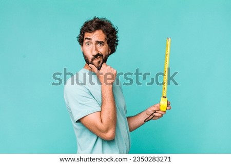 young adult hispanic crazy man with a medition meter Royalty-Free Stock Photo #2350283271