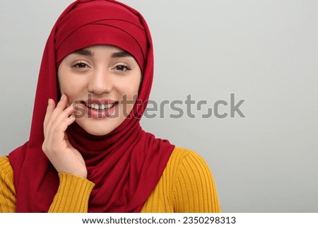 Muslim woman in hijab on light gray background, space for text