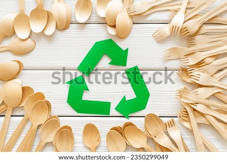 Eco friendly wooden cutlery with recycling sign. Zero waste concept.
