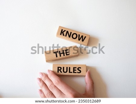 Know the rules symbol. Wooden blocks with words Know the rules. Beautiful white background. Businessman hand. Business and Know the rules concept. Copy space.