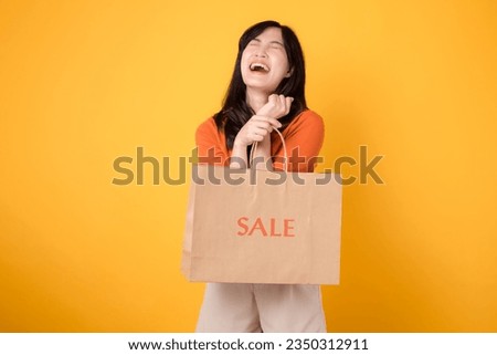 Discover excitement of surprising deals and joyful shopping. Trendy woman holds bags, embodying the happiness of finding the ultimate discounts. isolated on yellow background.