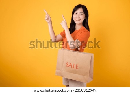 Trendy woman shopper choosing fashion pieces with a joyful smile, making the most of a sale event. Stylish purchases.